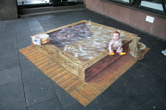 Baby posing with 3D optical illusion street painting for Fuji TV
