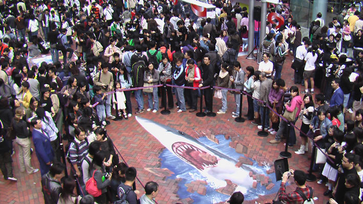 Line of people waiting to interact with 3D street art in Hong Kong