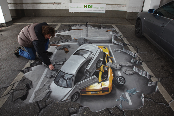 Street artist finishing trompe l'oeil for HDI insurance company
