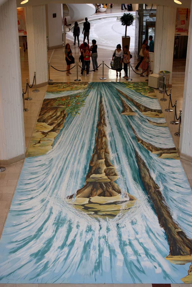 Upside down view of anamorphic street painting of a waterfall in Lyon, France
